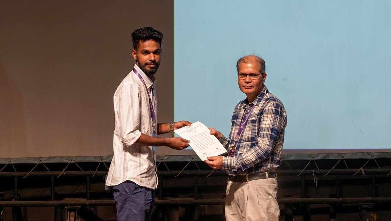 Amal receiving the award from Prof. D. K. Ojha, President of the Astronomical Society of India (ASI).